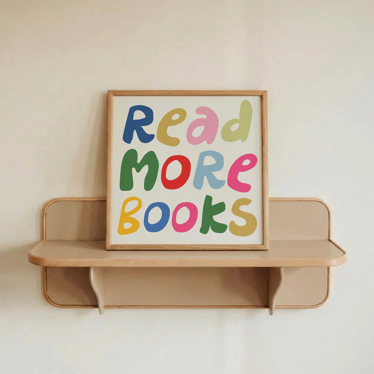 Square print with the words "Read More Books" in large multicolored bubble letters — blue, yellow, pink, green, red, and orange — stacked on three lines against a cream background.