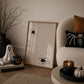 Set of 3 Halloween prints: a black background print with cartoon ghosts reading "We're so happy you're here," a checkered "Spooky Season" print, and a minimalist black spider illustration on a cream background.