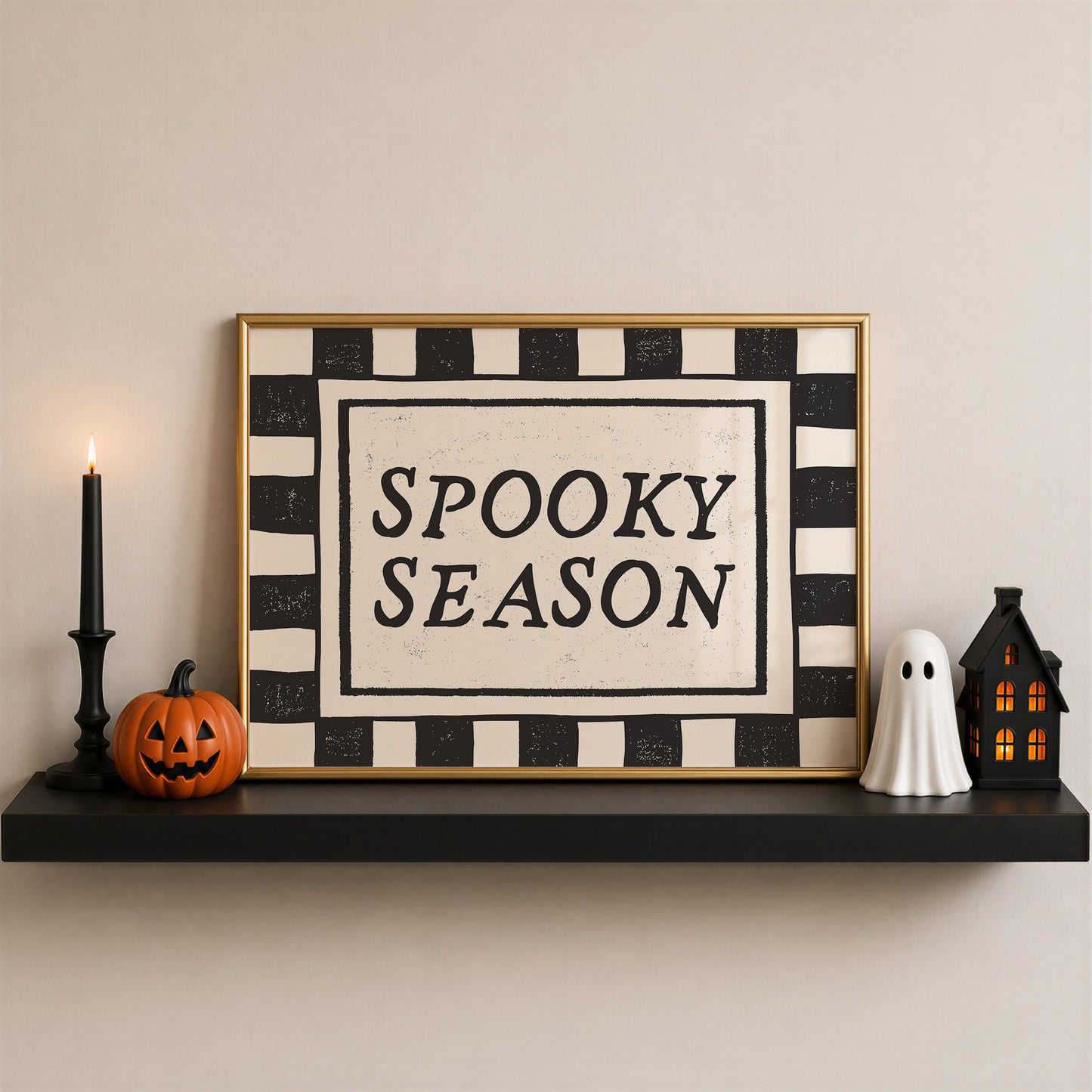 Set of 3 Halloween prints: a black background print with cartoon ghosts reading "We're so happy you're here," a checkered "Spooky Season" print, and a minimalist black spider illustration on a cream background.