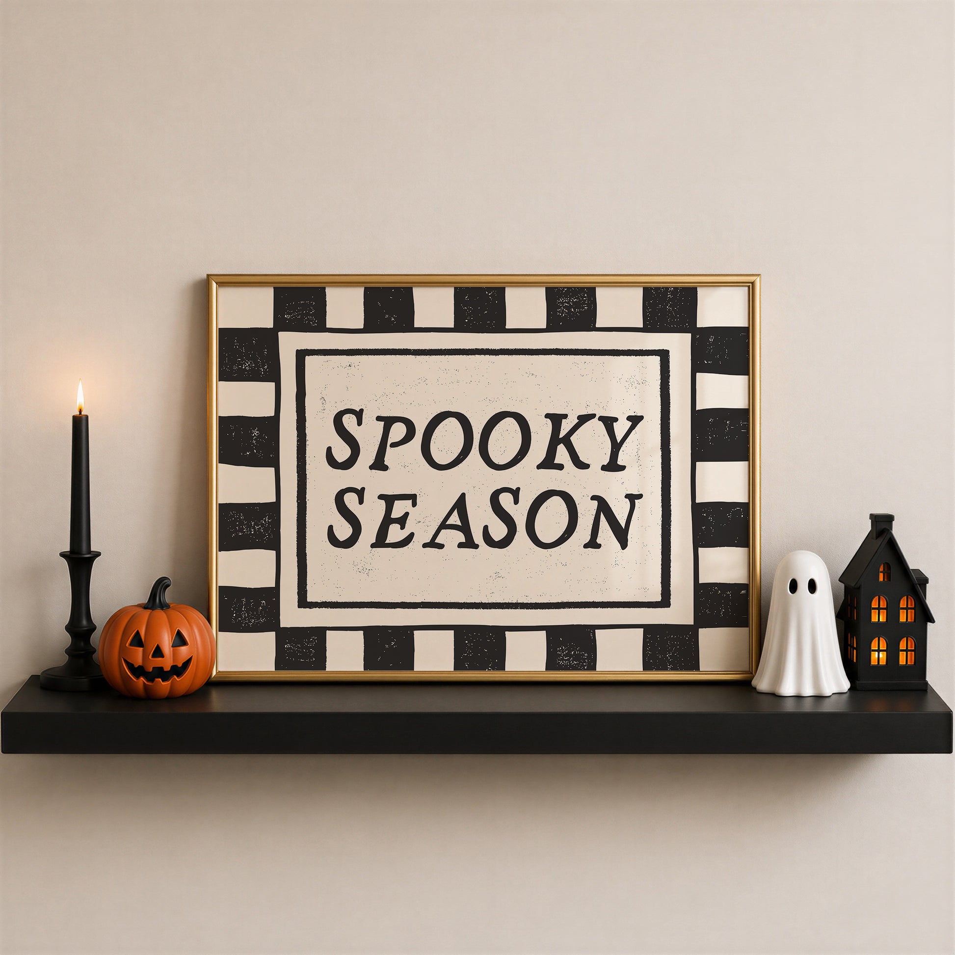 Set of 3 Halloween prints: a black background print with cartoon ghosts reading "We're so happy you're here," a checkered "Spooky Season" print, and a minimalist black spider illustration on a cream background.