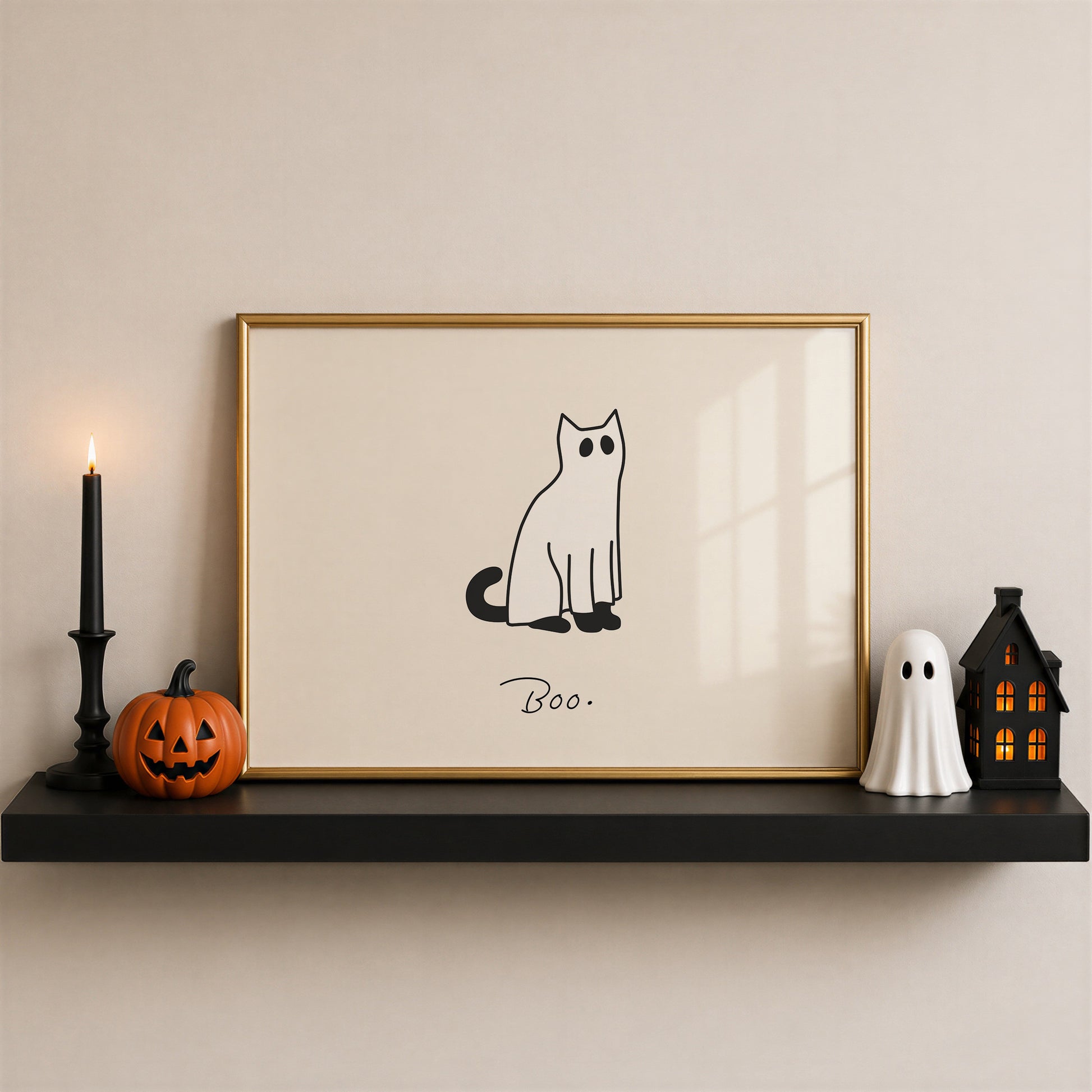 Horizontal minimalist print of a black cat wearing a white ghost sheet costume with cut-out eyes, sitting beside the handwritten word "Boo." on a cream background.