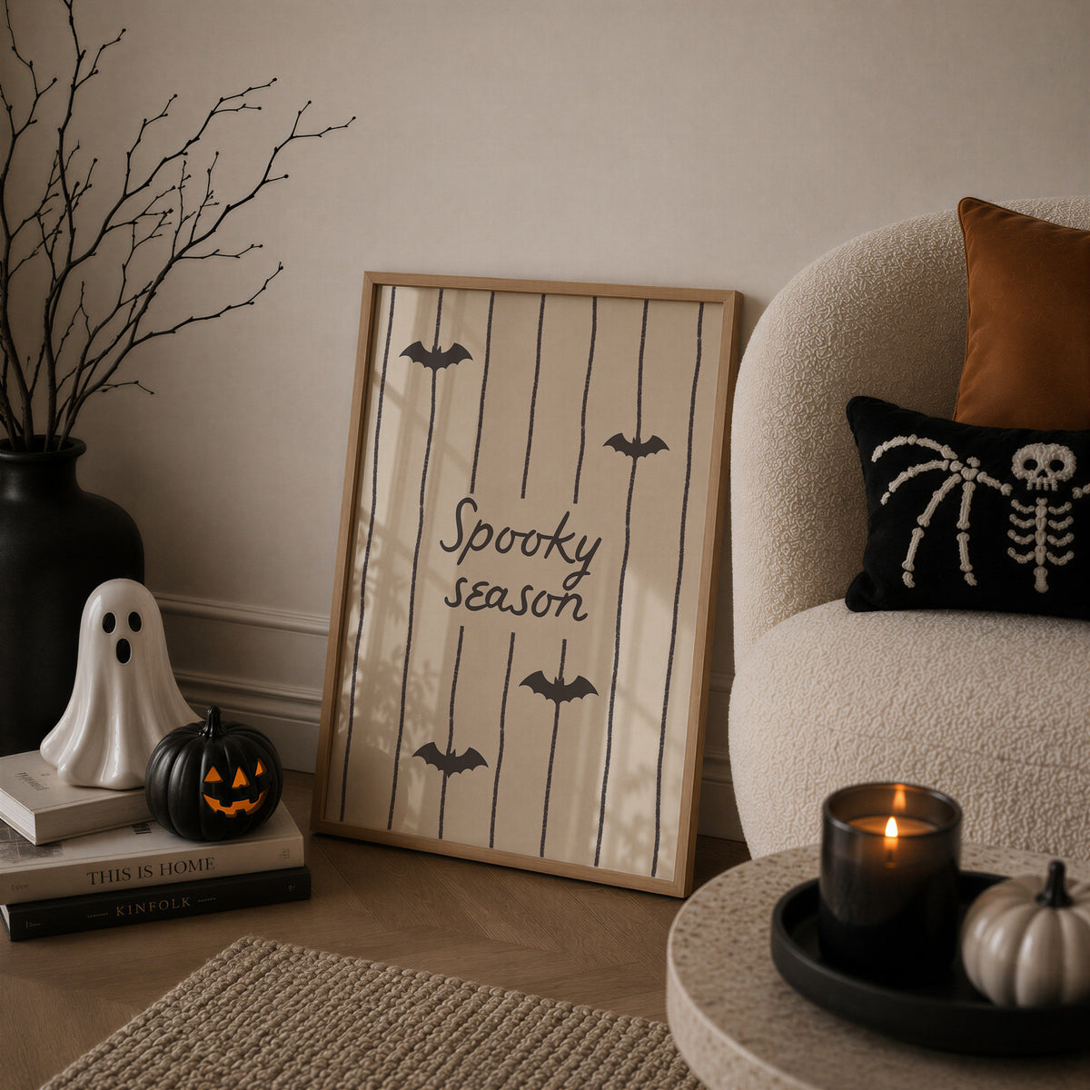 Portrait digital print with a tan and cream striped background featuring the hand-lettered phrase "Spooky season" in black script, accented with three minimalist black bat silhouettes.