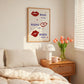 Cream print with three illustrated red lips paired with "Besos," "Bisous," and "Beijos" in navy lettering, with small red hearts scattered throughout