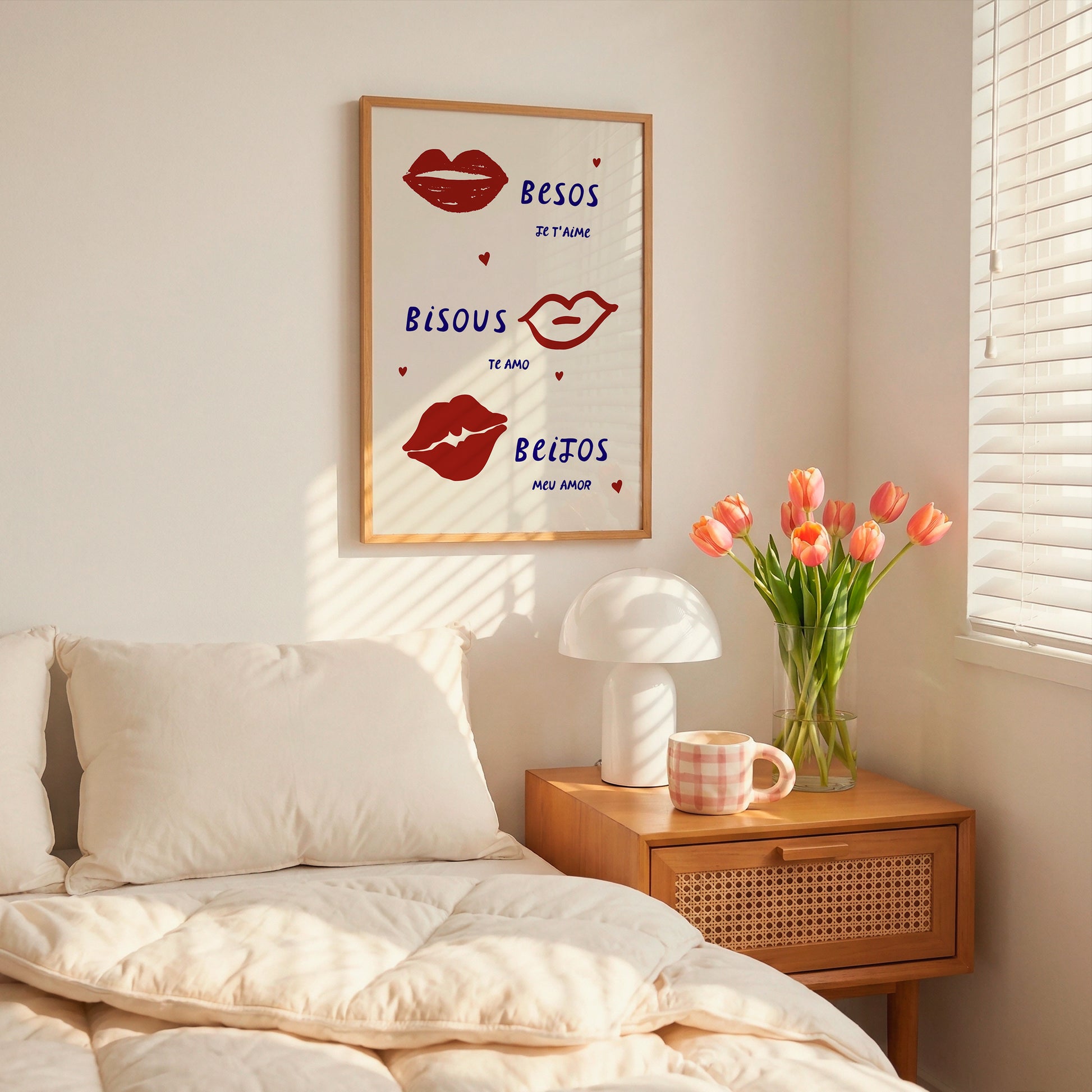 Cream print with three illustrated red lips paired with "Besos," "Bisous," and "Beijos" in navy lettering, with small red hearts scattered throughout