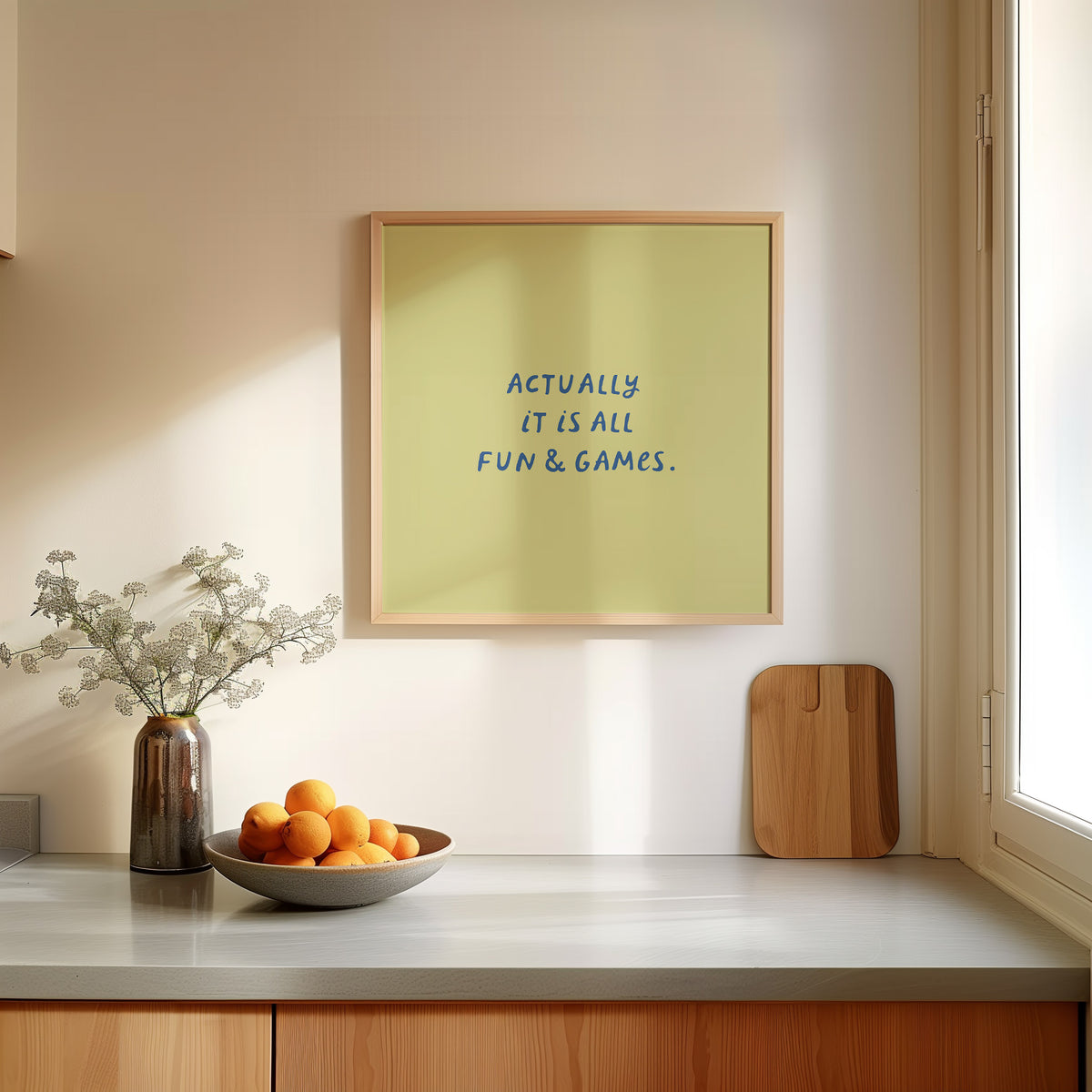 Square print with an olive green background and the quote "Actually it is all fun & games." in bold blue hand-lettered type.