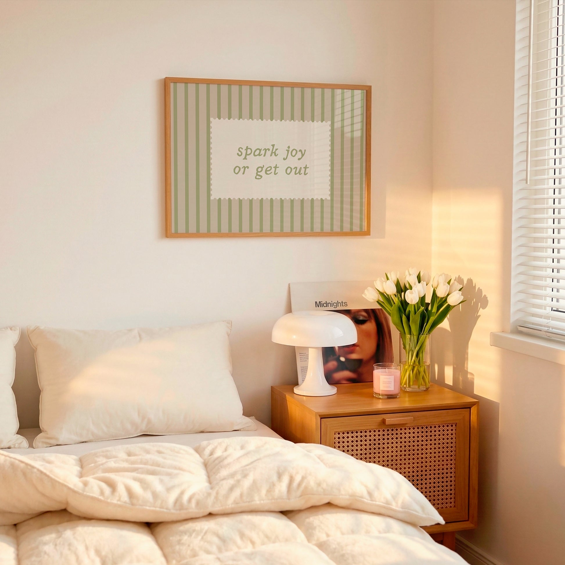 Horizontal wall print with soft sage green vertical stripes and a cream scalloped border text box reading spark joy or get out in matching sage green cursive font