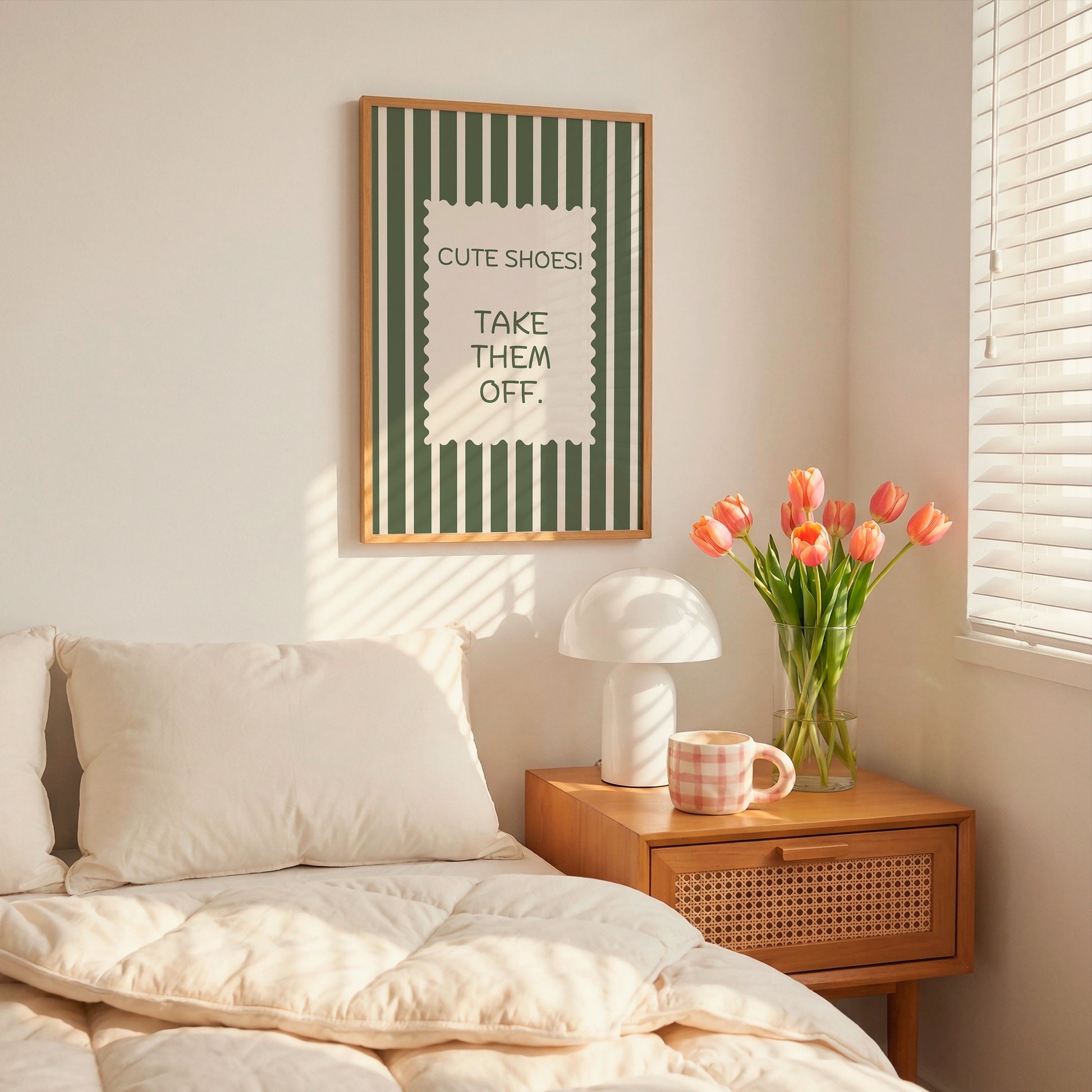 Vertical wall print with bold olive green and cream vertical stripes and a cream scalloped border text box reading Cute Shoes! Take Them Off. in matching green serif typography