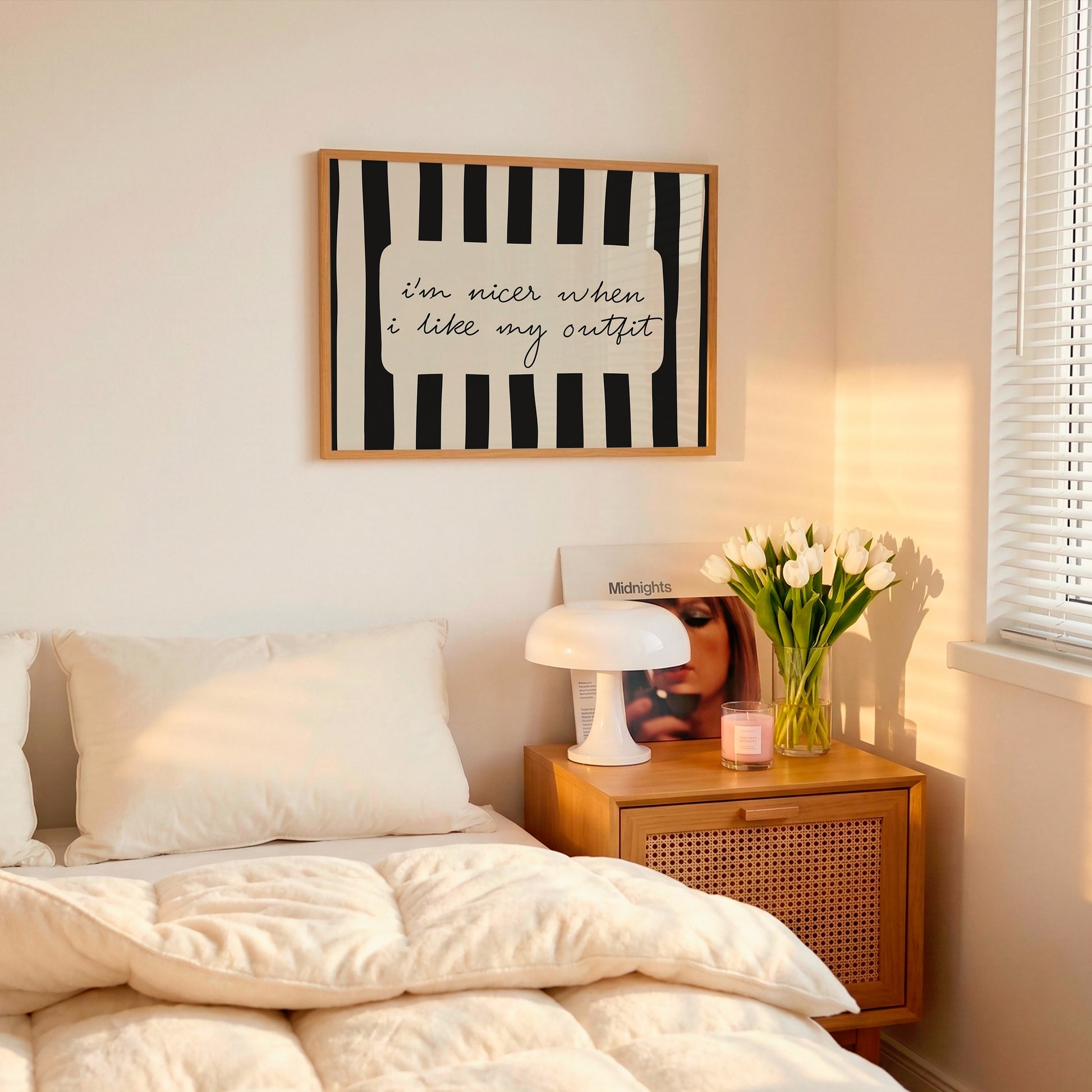 Horizontal print with bold black and white vertical stripes framing the handwritten cursive quote "i'm nicer when I like my outfit" in a rounded cream panel.
