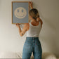 Set of 10 calm corner prints in tan and blue: "Take Your Time," "I am enough" on a smiley face, "Breathe" beside a meditating duck illustration, a "Daily Check-in, All Feelings Welcome!" chart with cartoon stars and clouds, "Slow Down, You're Doing Fine!", "You are enough," "Be Kind To Your Mind" on a checkered background, "This is a Safe Space" on a house shape, "The way you speak to yourself matters" beside a heart illustration, and "It's OK to Not Be OK."