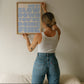 Square wall print on a warm cream background with bold periwinkle blue chunky mixed typography reading Hey! Slow down You're Fine You got this