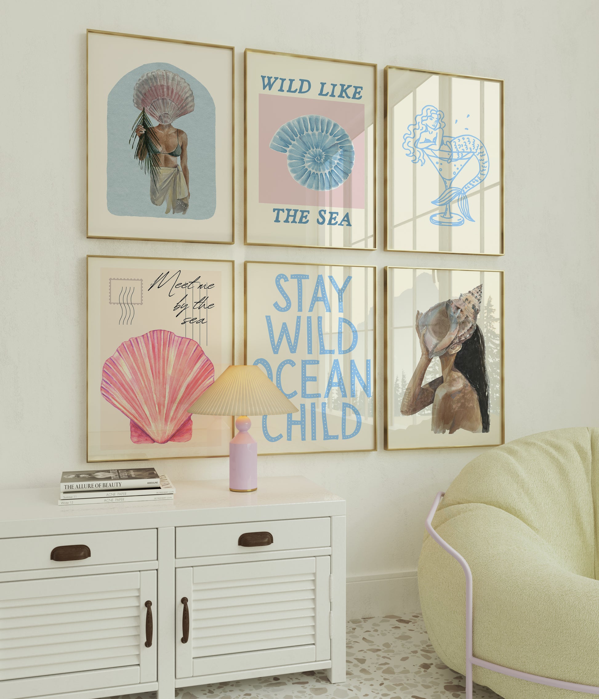 Set of 10 coastal watercolor prints in pink and blue: "Wild Like the Sea" beside a spiral shell illustration, "Stay Wild Ocean Child" in bold blue lettering, "Sea La Vie" in pink stamped typography, a mermaid lounging in a martini glass, pink starfish and seashell illustrations, a woman in a shell headdress, a beach umbrella watercolor, and "Meet me by the sea" in postcard-style script.