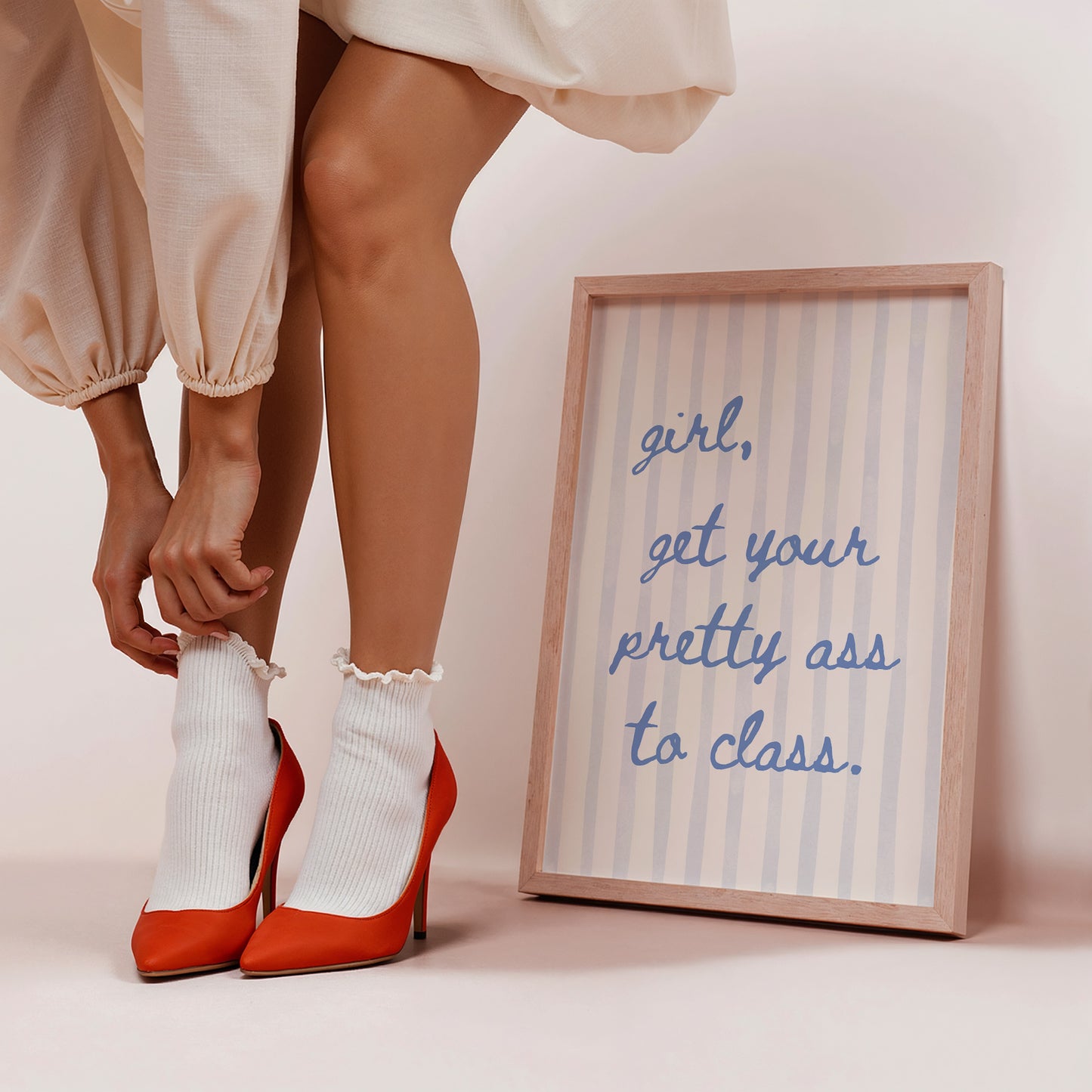 Vertical print with the handwritten cursive quote "girl, get your pretty ass to class." in blue script on a cream background with soft hand-painted pale blue vertical stripes.