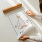 Set of 10 calm corner prints in tan and blue: "Take Your Time," "I am enough" on a smiley face, "Breathe" beside a meditating duck illustration, a "Daily Check-in, All Feelings Welcome!" chart with cartoon stars and clouds, "Slow Down, You're Doing Fine!", "You are enough," "Be Kind To Your Mind" on a checkered background, "This is a Safe Space" on a house shape, "The way you speak to yourself matters" beside a heart illustration, and "It's OK to Not Be OK."