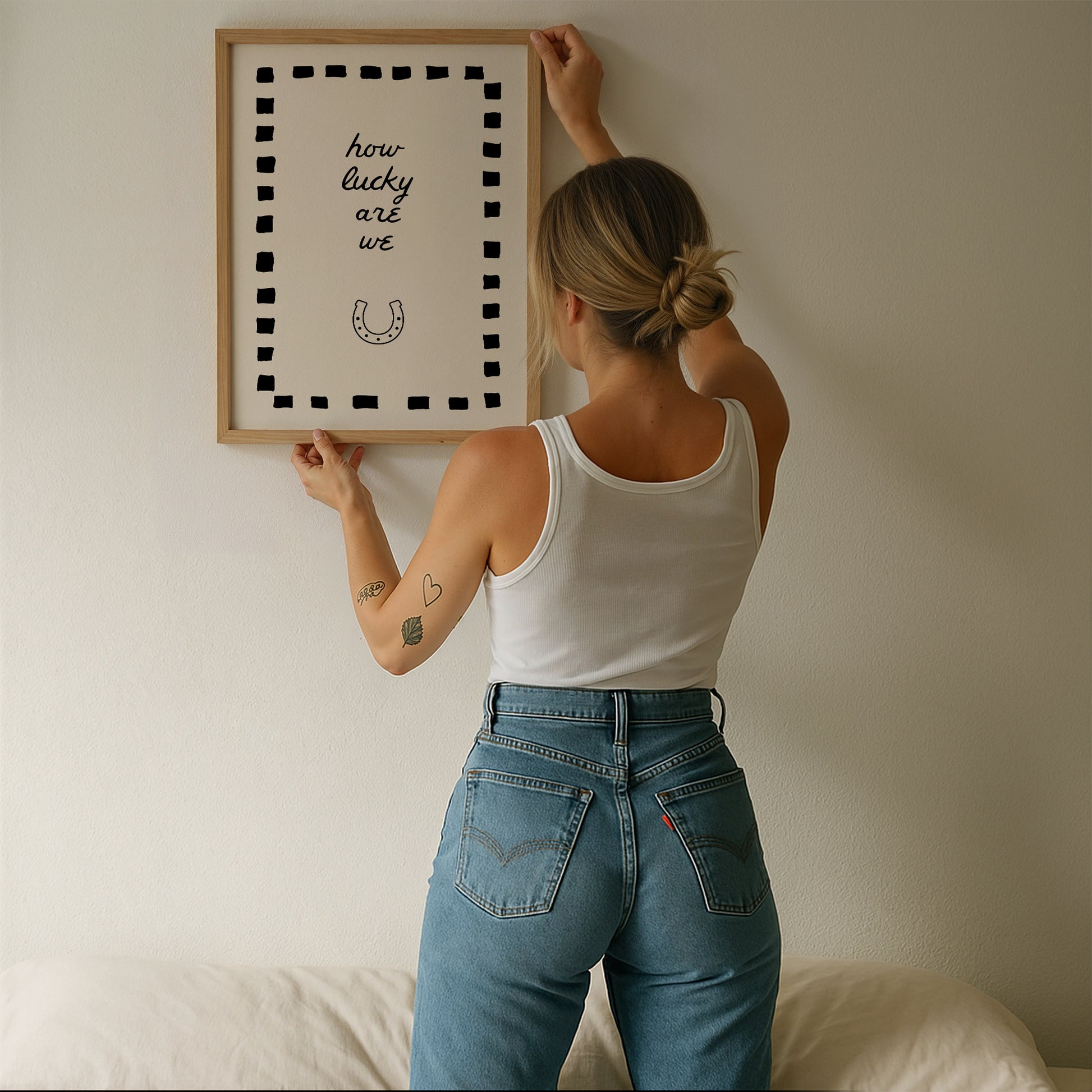 Cream print with a black dashed border featuring the handwritten quote 'how lucky are we' and a horseshoe illustration