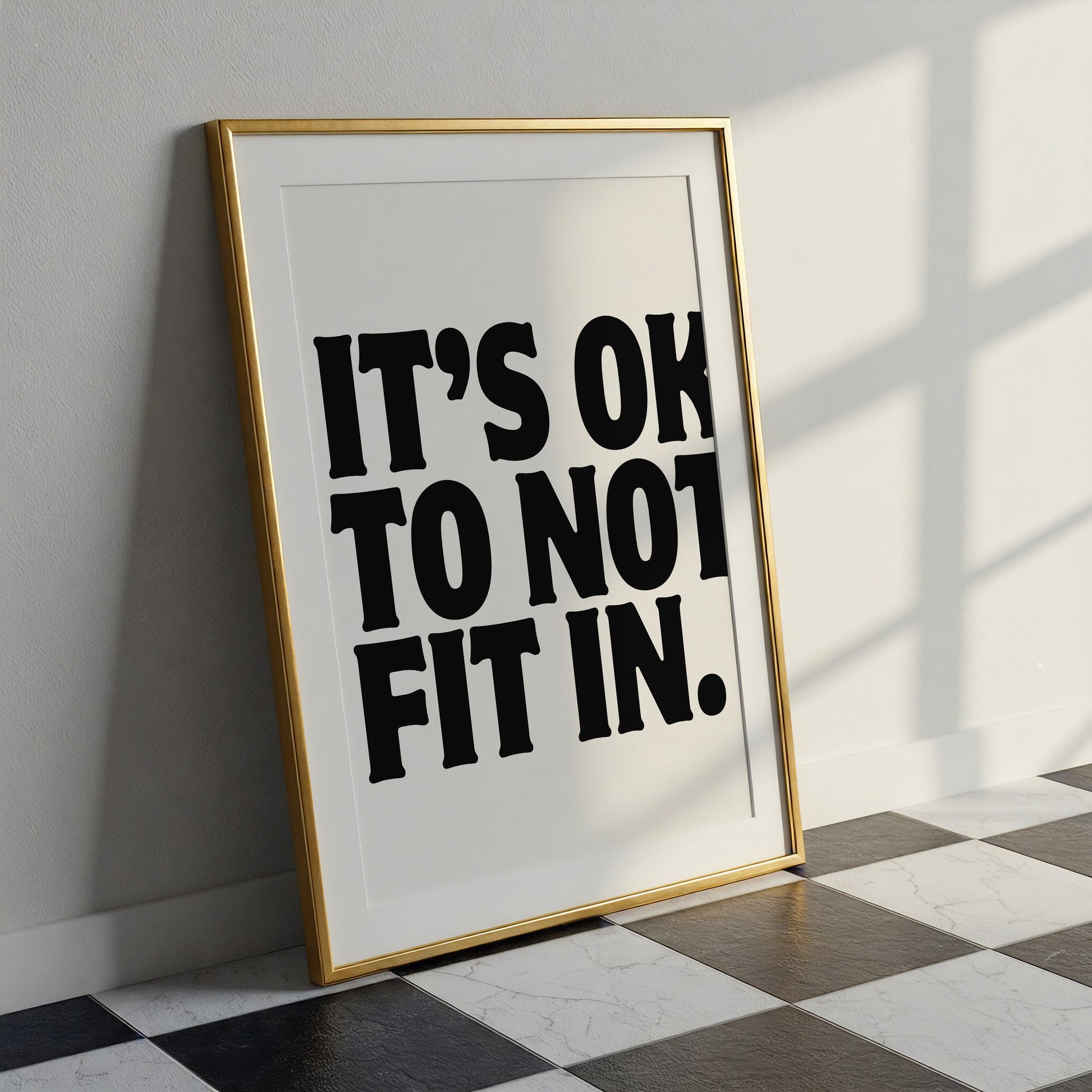 Square cream wall print with bold oversized black chunky typography reading It's Ok To Not Fit In on a clean white background