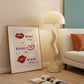 Cream print with three illustrated red lips paired with "Besos," "Bisous," and "Beijos" in navy lettering, with small red hearts scattered throughout