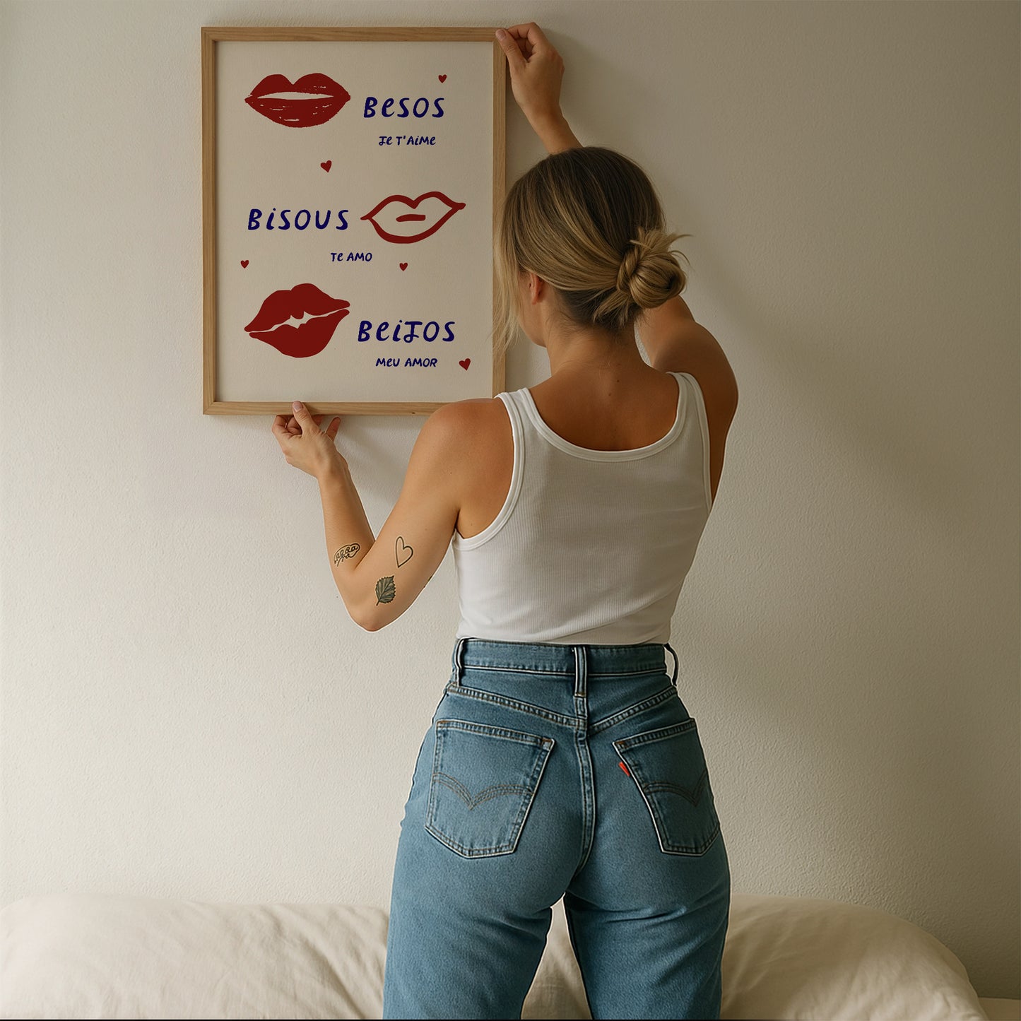 Cream print with three illustrated red lips paired with "Besos," "Bisous," and "Beijos" in navy lettering, with small red hearts scattered throughout