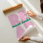 Vertical print with the word "READ" in oversized pink bubble letters and "more books" in green cursive script layered across it, on a white background.