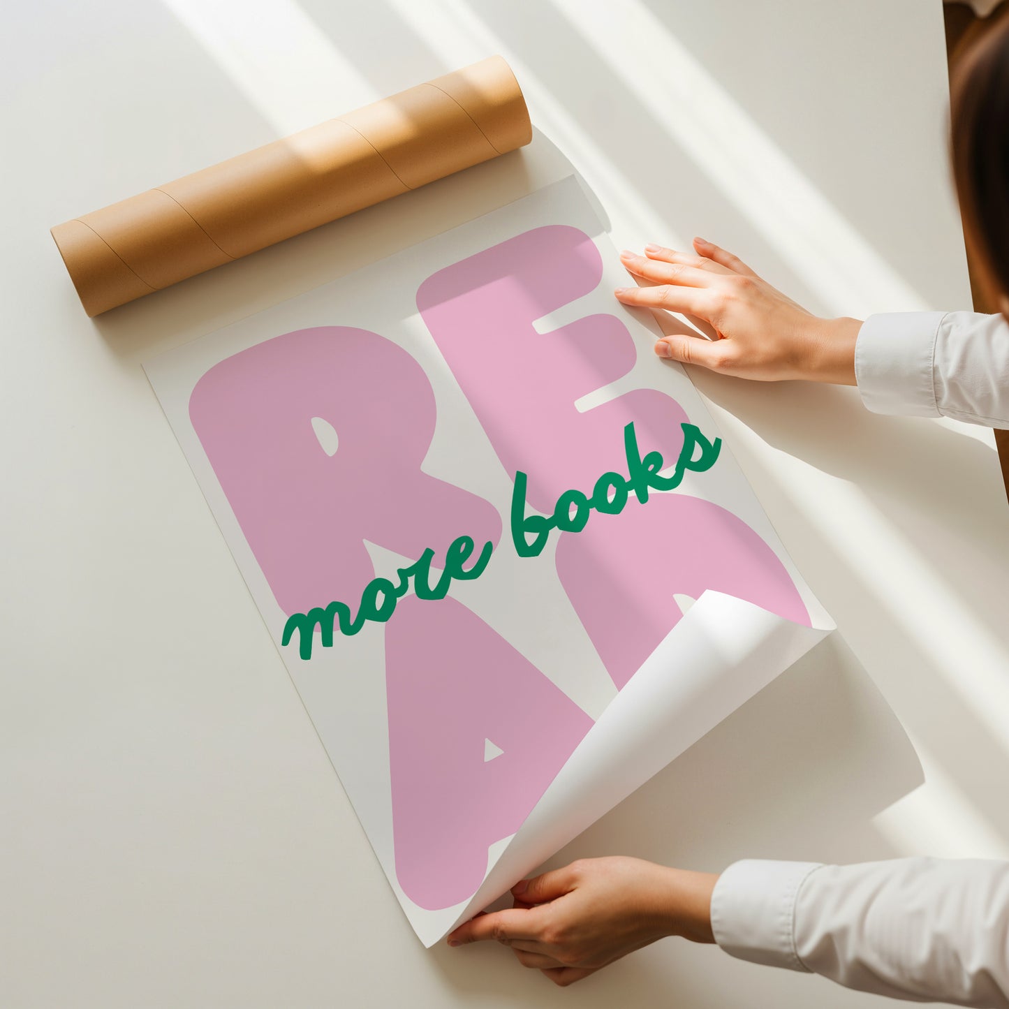Vertical print with the word "READ" in oversized pink bubble letters and "more books" in green cursive script layered across it, on a white background.