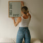 Vertical wall print with soft sage green wavy vertical stripes and bold dark green chunky typography reading LOVE YOU vertically on the left and BYE! horizontally at the bottom right