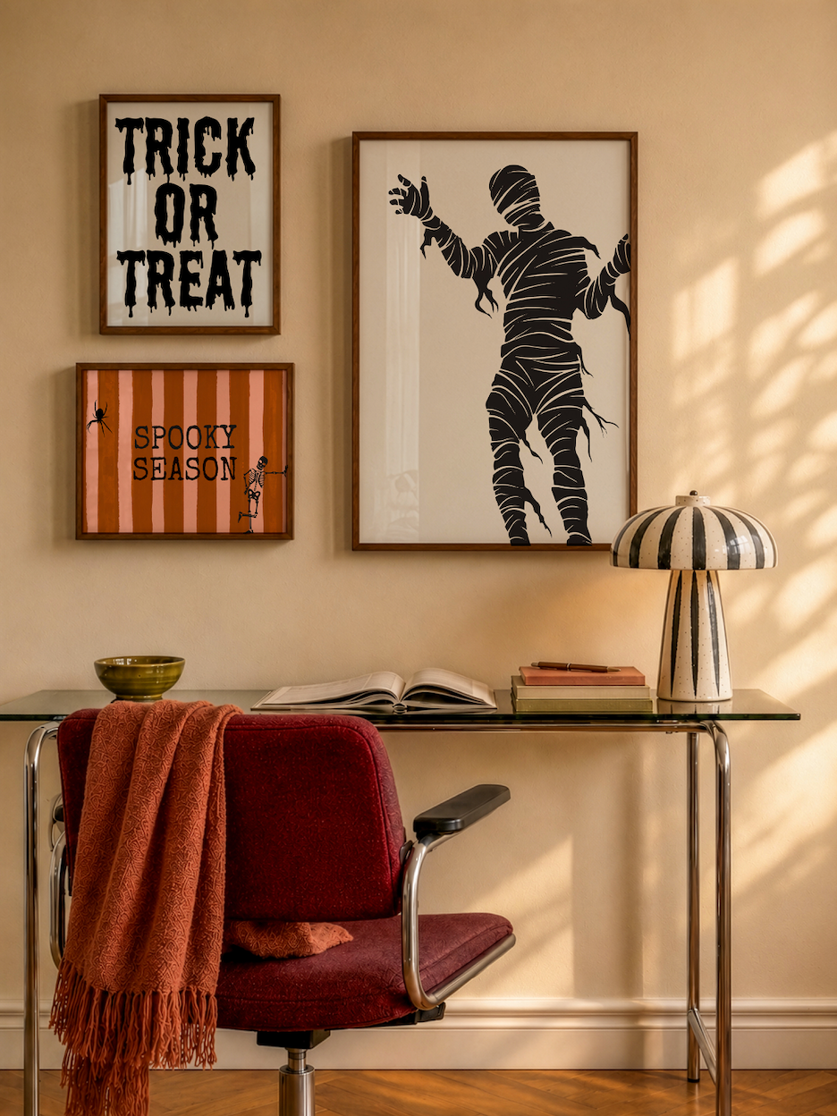 Set of 3 Halloween prints: "Trick or Treat" in dripping black lettering, "Spooky Season" on orange striped fabric with a spider and skeleton, and a bold black silhouette of a mummy.