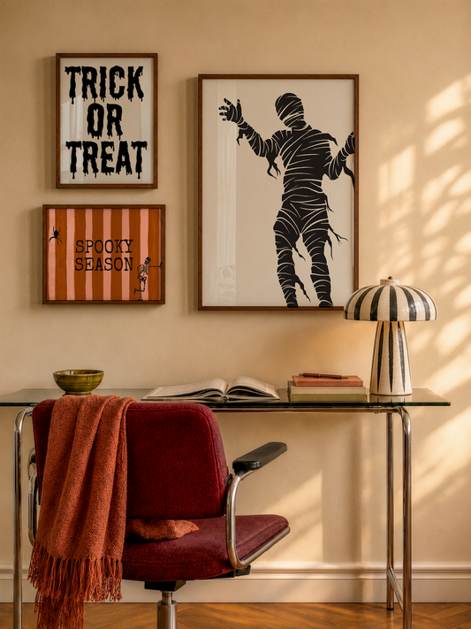 Set of 3 Halloween prints: "Trick or Treat" in dripping black lettering, "Spooky Season" on orange striped fabric with a spider and skeleton, and a bold black silhouette of a mummy.