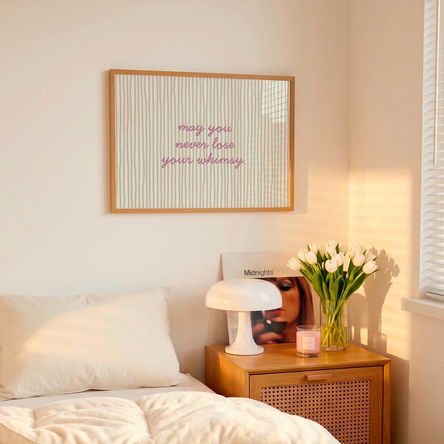 Horizontal wall print with soft sage green wavy vertical stripes and delicate pink cursive script reading may you never lose your whimsy on a warm cream background